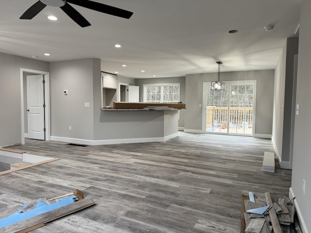 unfurnished living room with hardwood / wood-style flooring and ceiling fan