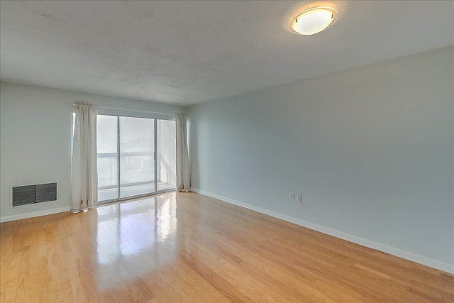 spare room featuring light wood-type flooring