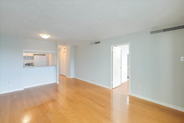 unfurnished living room with light hardwood / wood-style flooring