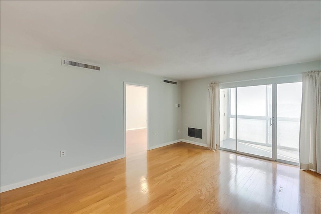 empty room with light hardwood / wood-style floors