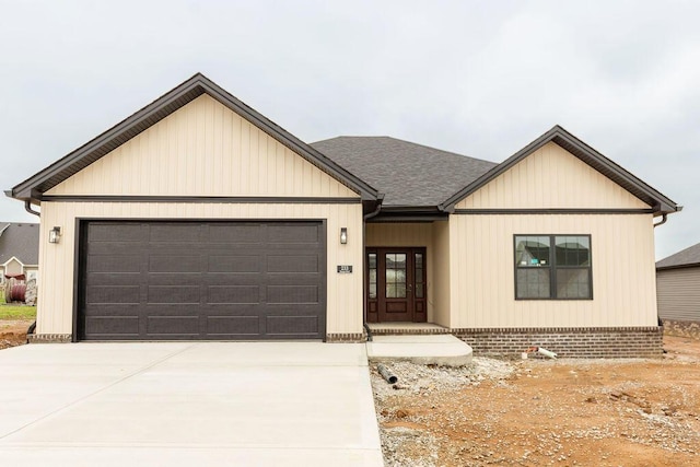 view of front of property featuring concrete driveway and an attached garage