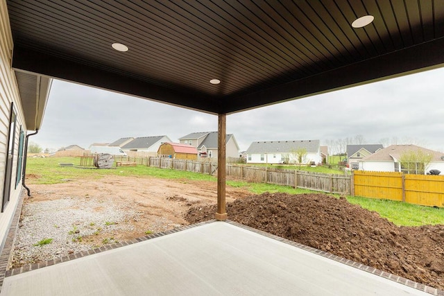 view of patio / terrace with fence and a residential view