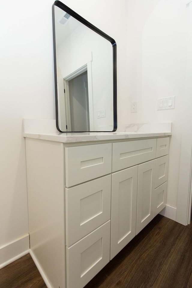 room details featuring baseboards and wood finished floors