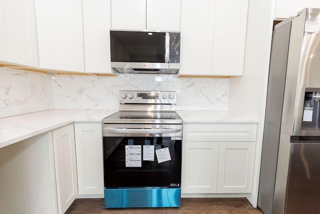kitchen featuring decorative backsplash, white cabinetry, and stainless steel appliances