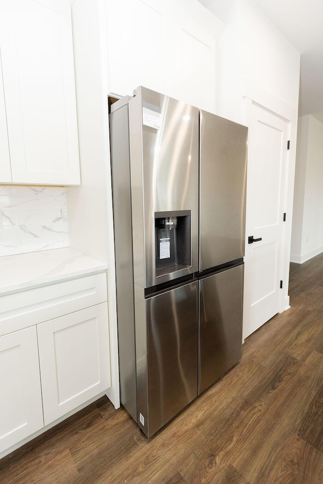 kitchen with backsplash, dark wood finished floors, stainless steel refrigerator with ice dispenser, and white cabinets