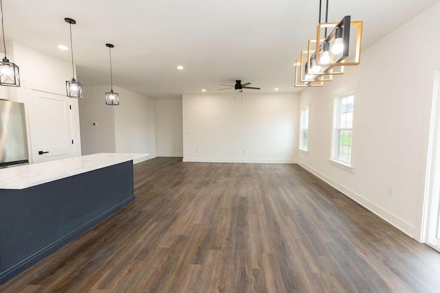 unfurnished living room featuring recessed lighting, a ceiling fan, baseboards, and dark wood-style flooring