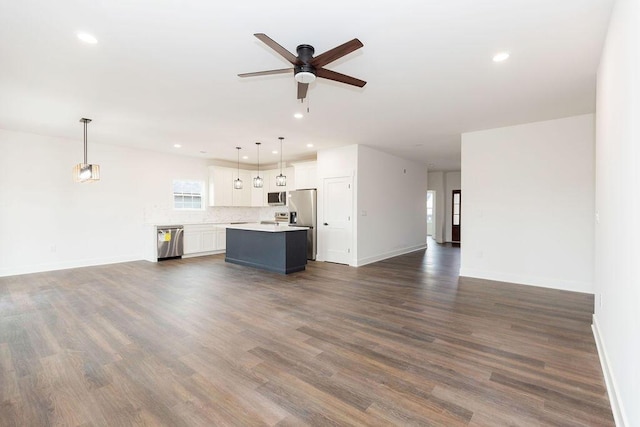 unfurnished living room featuring a ceiling fan, a healthy amount of sunlight, and recessed lighting