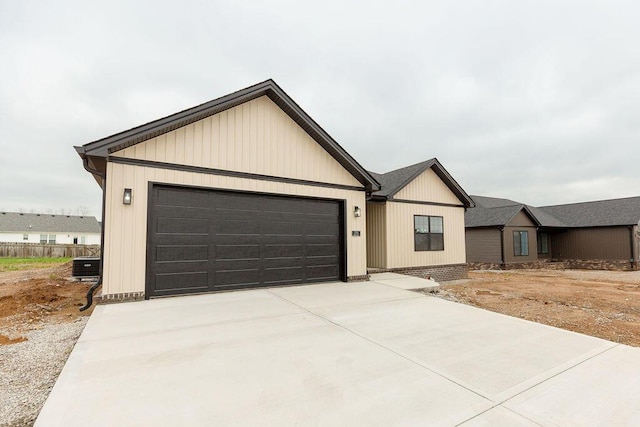 modern farmhouse featuring concrete driveway and a garage