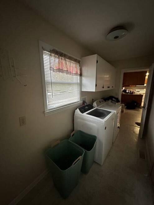 laundry area with cabinets and separate washer and dryer