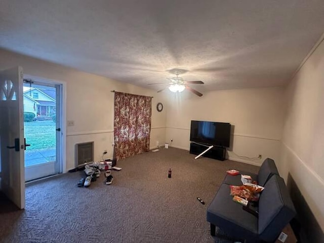 carpeted living room with a wealth of natural light and ceiling fan