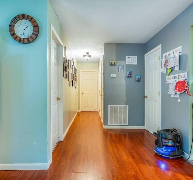 hall with hardwood / wood-style flooring