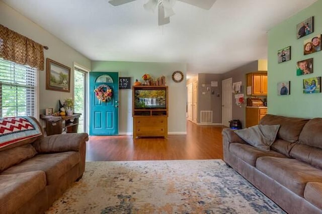 living room with ceiling fan and light hardwood / wood-style flooring