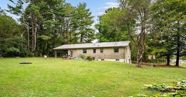 rear view of property with a lawn