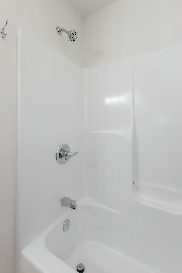 bathroom with shower / washtub combination