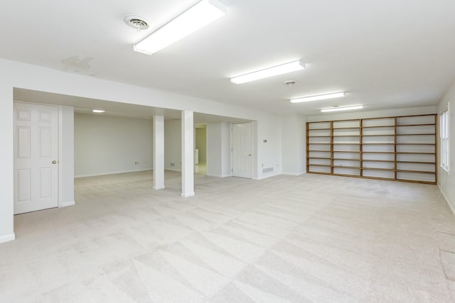 basement featuring light colored carpet