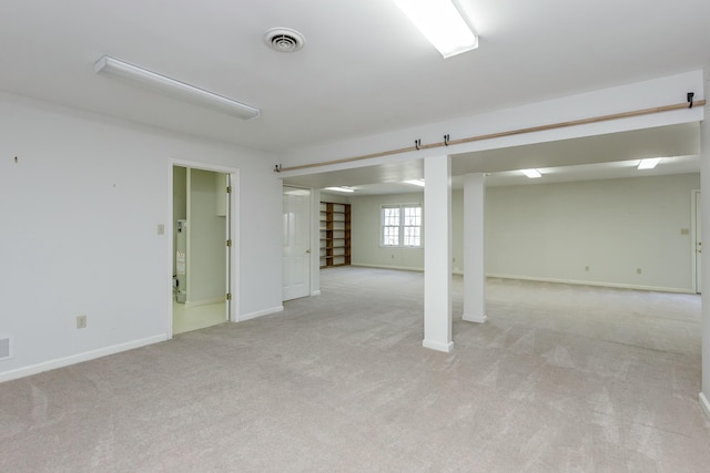 basement featuring light colored carpet