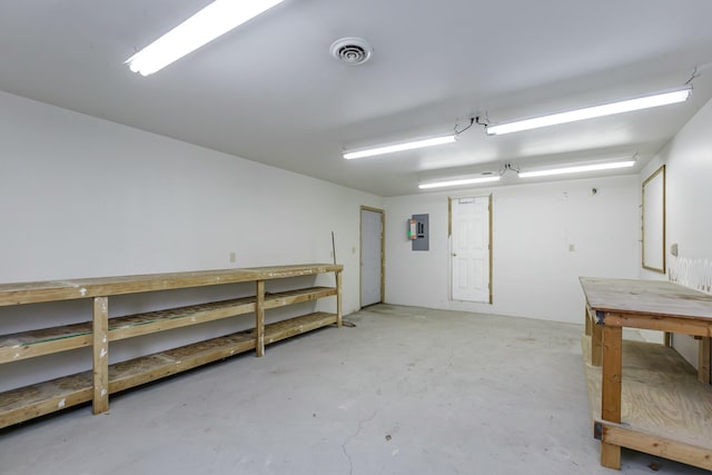 basement featuring electric panel and a workshop area