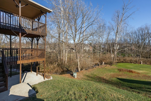 view of yard featuring a patio area and a wooden deck