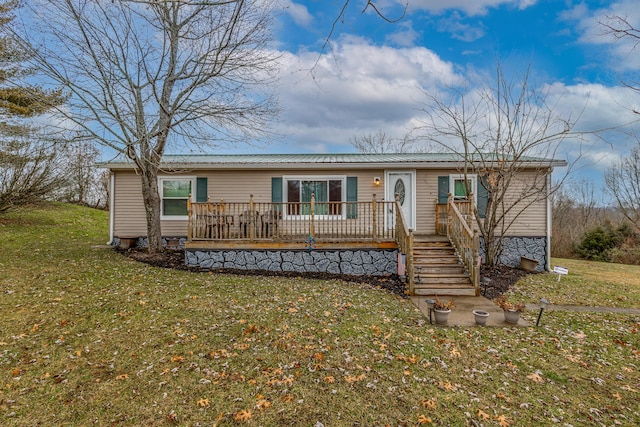 view of front of property featuring a deck and a front lawn