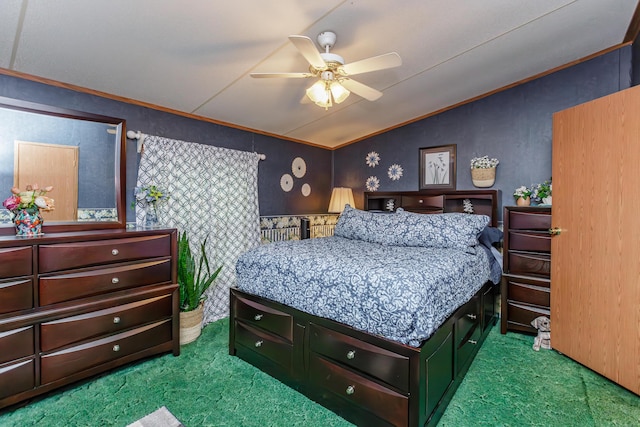 carpeted bedroom featuring vaulted ceiling, ceiling fan, and crown molding