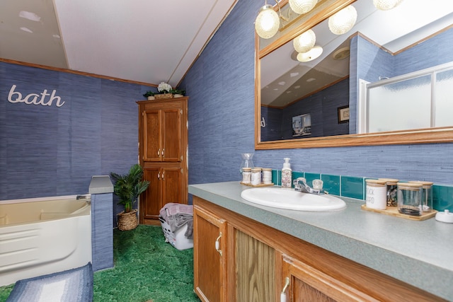 bathroom featuring a bathing tub, vanity, and lofted ceiling