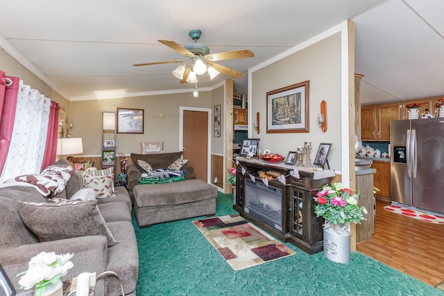 living room featuring dark hardwood / wood-style flooring, vaulted ceiling, ceiling fan, and crown molding