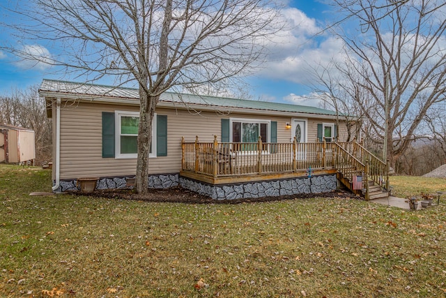 back of house with a yard and a deck