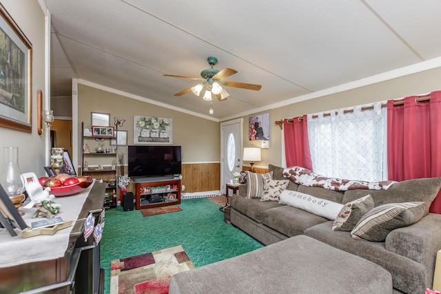 living room with wood walls, crown molding, vaulted ceiling, carpet flooring, and ceiling fan