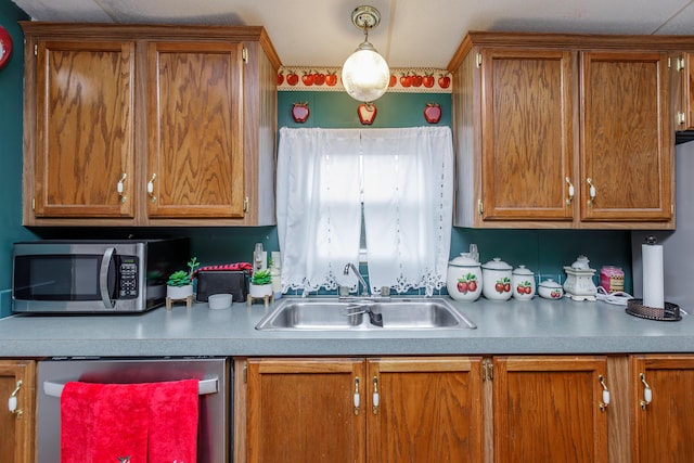 kitchen with sink, pendant lighting, and appliances with stainless steel finishes