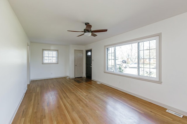 empty room featuring ceiling fan and light hardwood / wood-style flooring