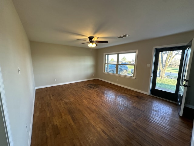 unfurnished room with dark hardwood / wood-style floors and ceiling fan