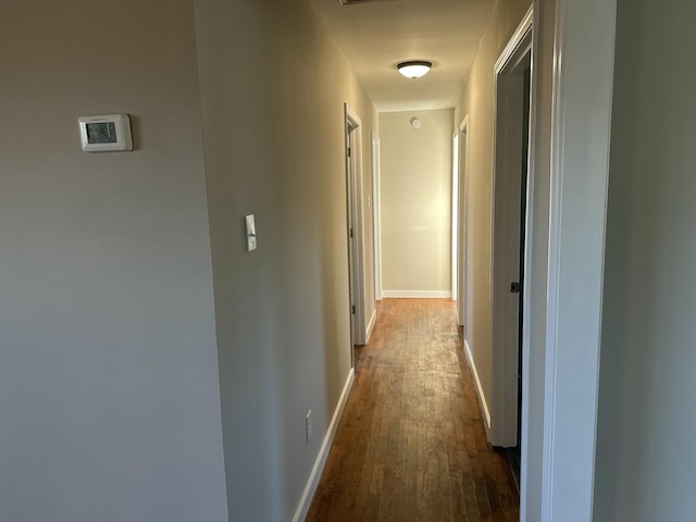 hallway with dark hardwood / wood-style floors