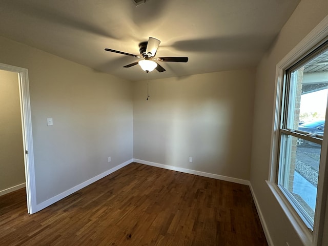 unfurnished room with dark hardwood / wood-style floors and ceiling fan