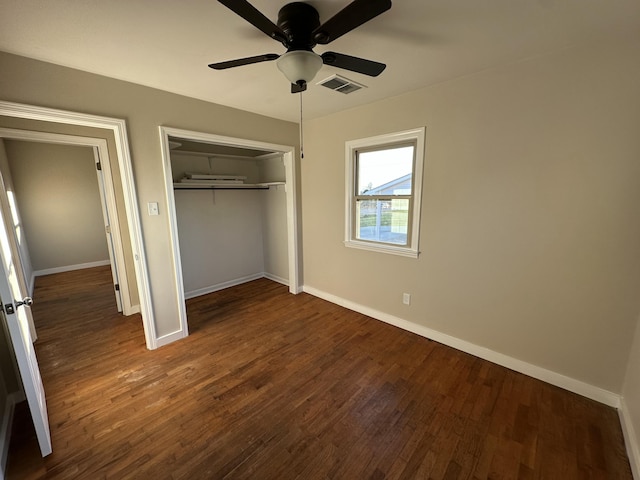 unfurnished bedroom with ceiling fan, a closet, and dark wood-type flooring