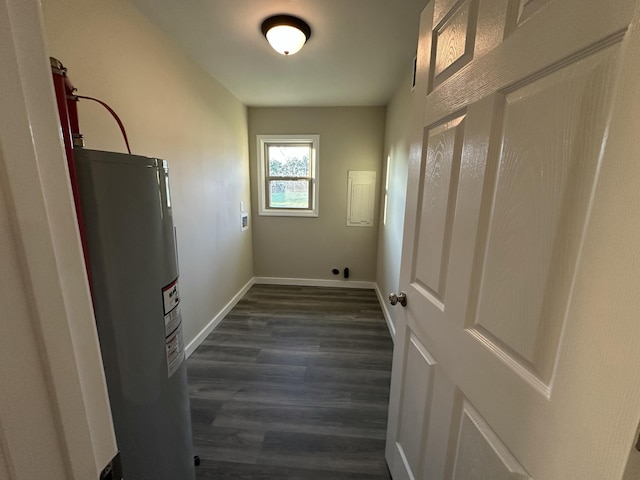 laundry area with electric water heater and dark hardwood / wood-style floors