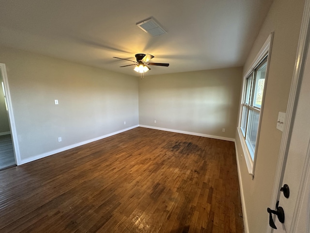 spare room featuring ceiling fan and dark hardwood / wood-style flooring