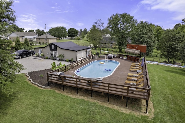 view of swimming pool featuring a lawn