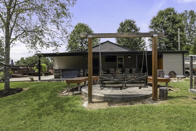 rear view of house with a patio, a hot tub, and a lawn