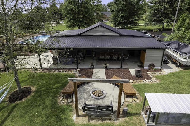 rear view of house with a patio area and a lawn