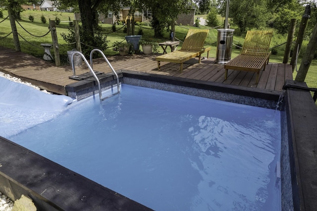 view of pool with a yard and a deck