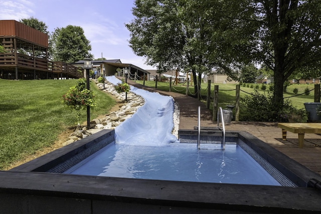 view of home's community with a lawn and a wooden deck