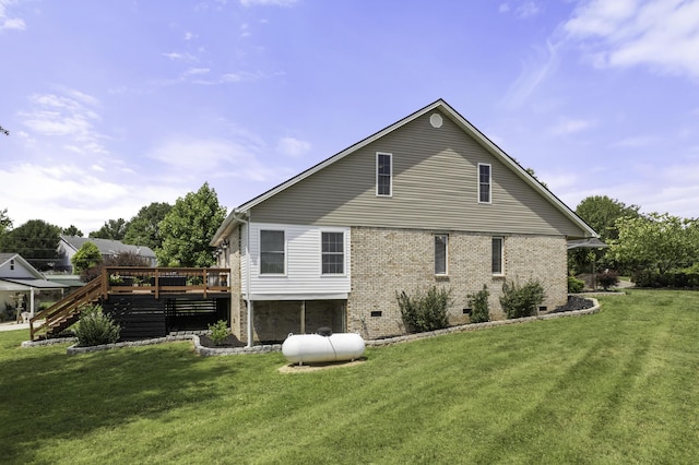 back of property featuring a yard and a wooden deck