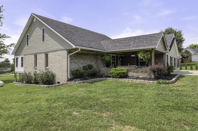 view of side of home with a lawn