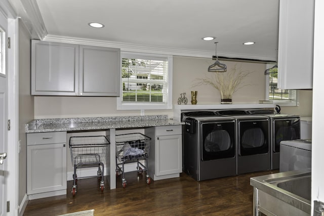 washroom featuring dark hardwood / wood-style floors, a healthy amount of sunlight, separate washer and dryer, and crown molding