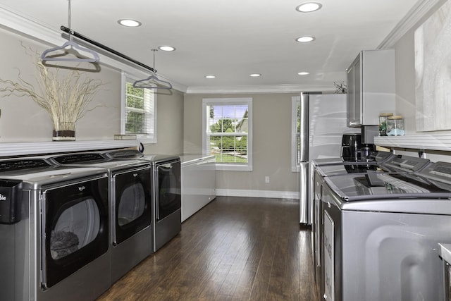 laundry area featuring washer and clothes dryer, crown molding, and dark wood-type flooring