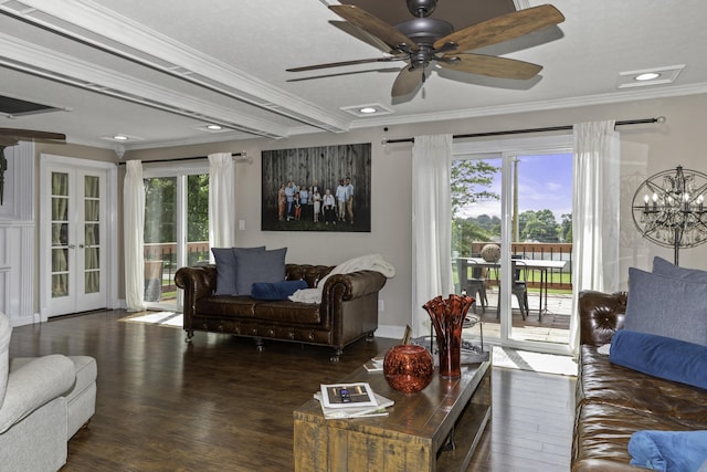 living room featuring ceiling fan with notable chandelier, ornamental molding, dark wood-type flooring, and french doors