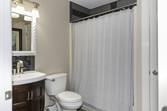 bathroom with decorative backsplash, a shower with curtain, vanity, and toilet