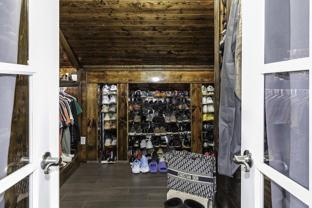 walk in closet with vaulted ceiling and dark wood-type flooring