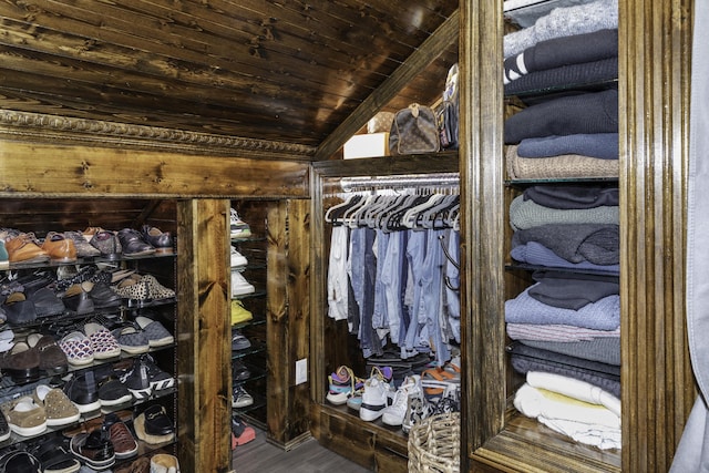 spacious closet with hardwood / wood-style floors and vaulted ceiling