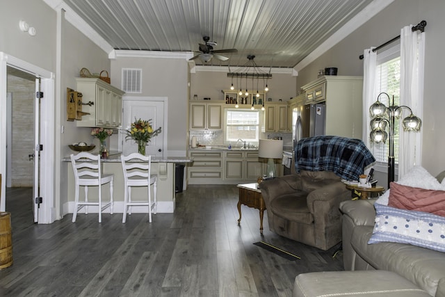 living room with ceiling fan, ornamental molding, sink, and dark wood-type flooring